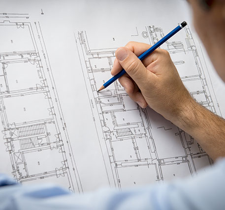 Man pointing the pencil to the floor plan.