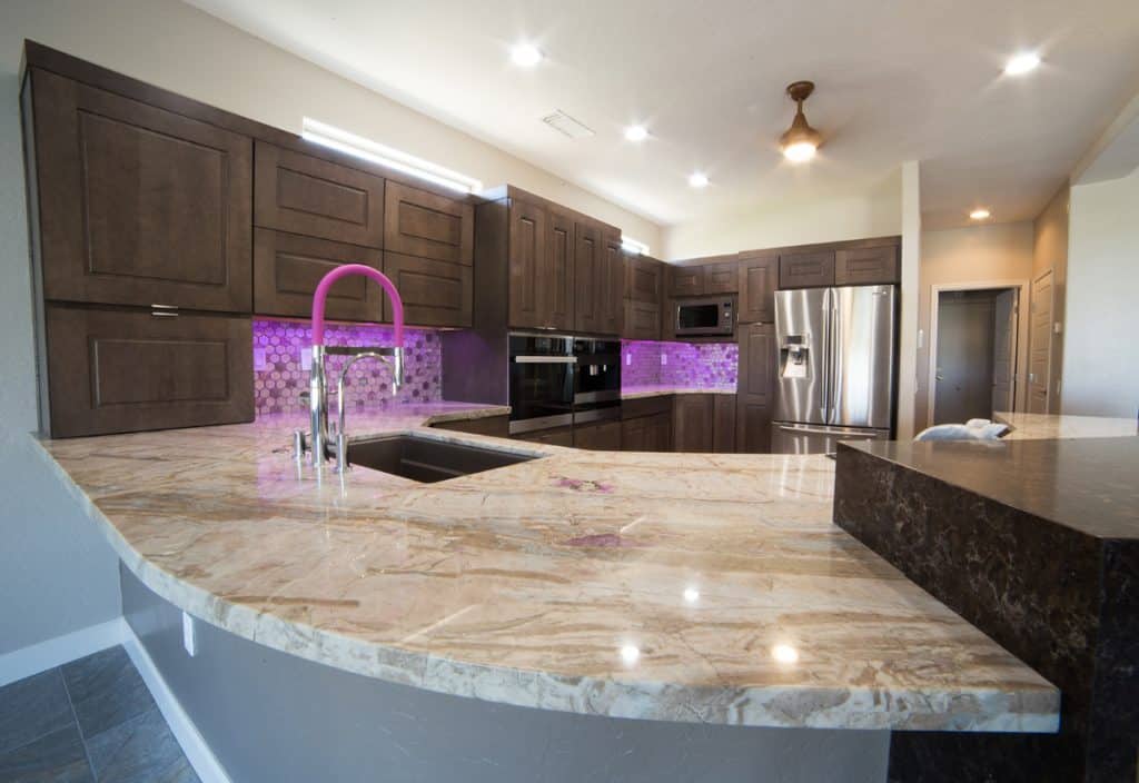 Marble table and dark brown cabinets.